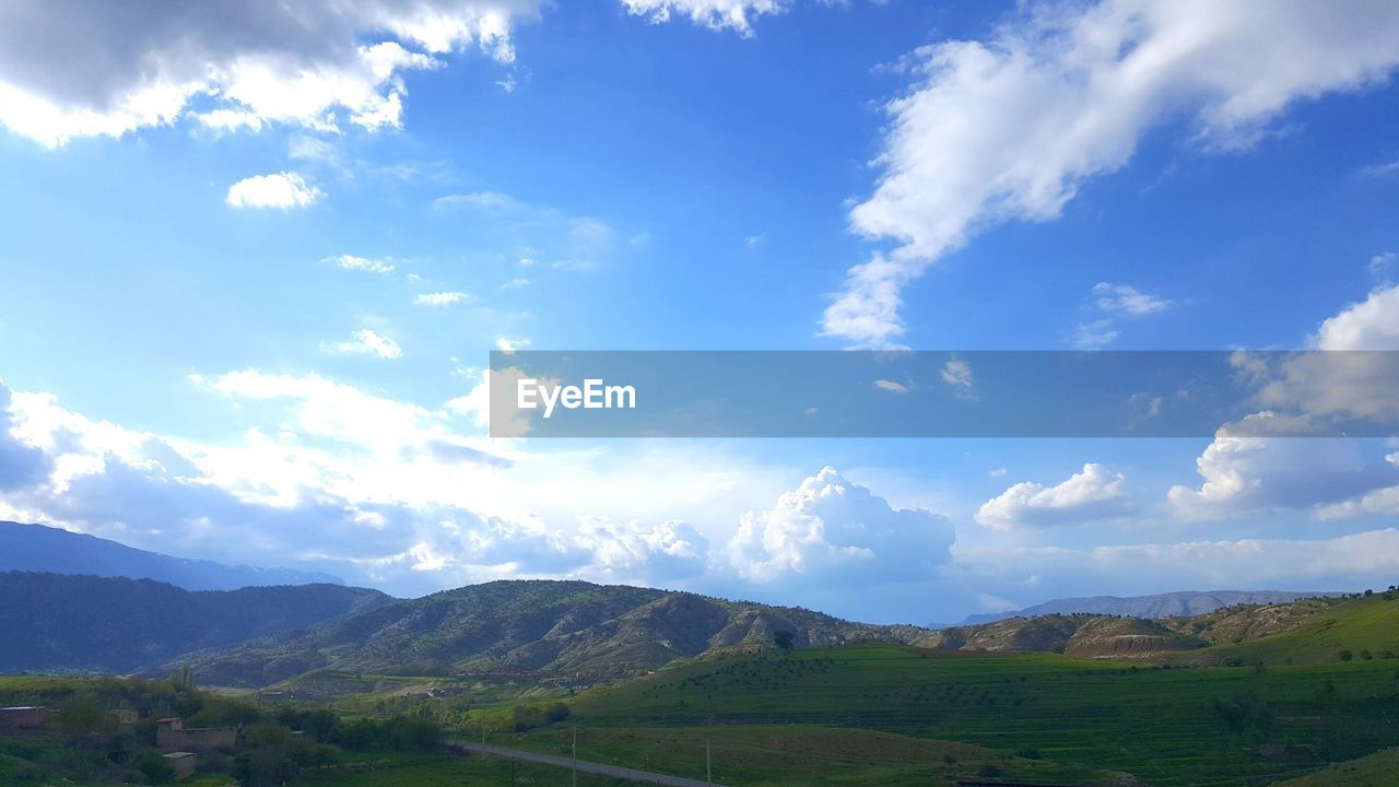 Scenic view of mountains against cloudy sky