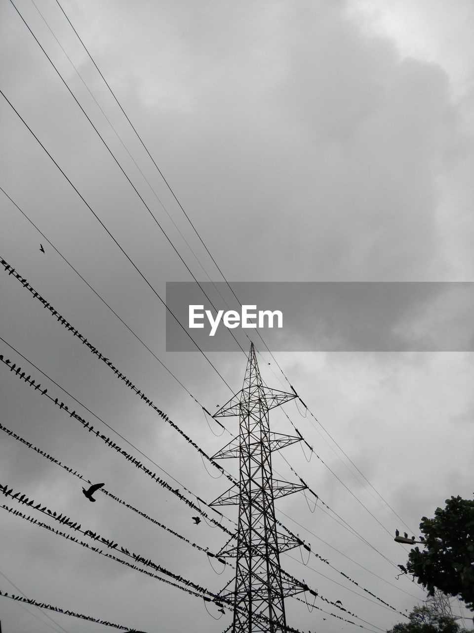 Low angle view of electricity pylon against sky