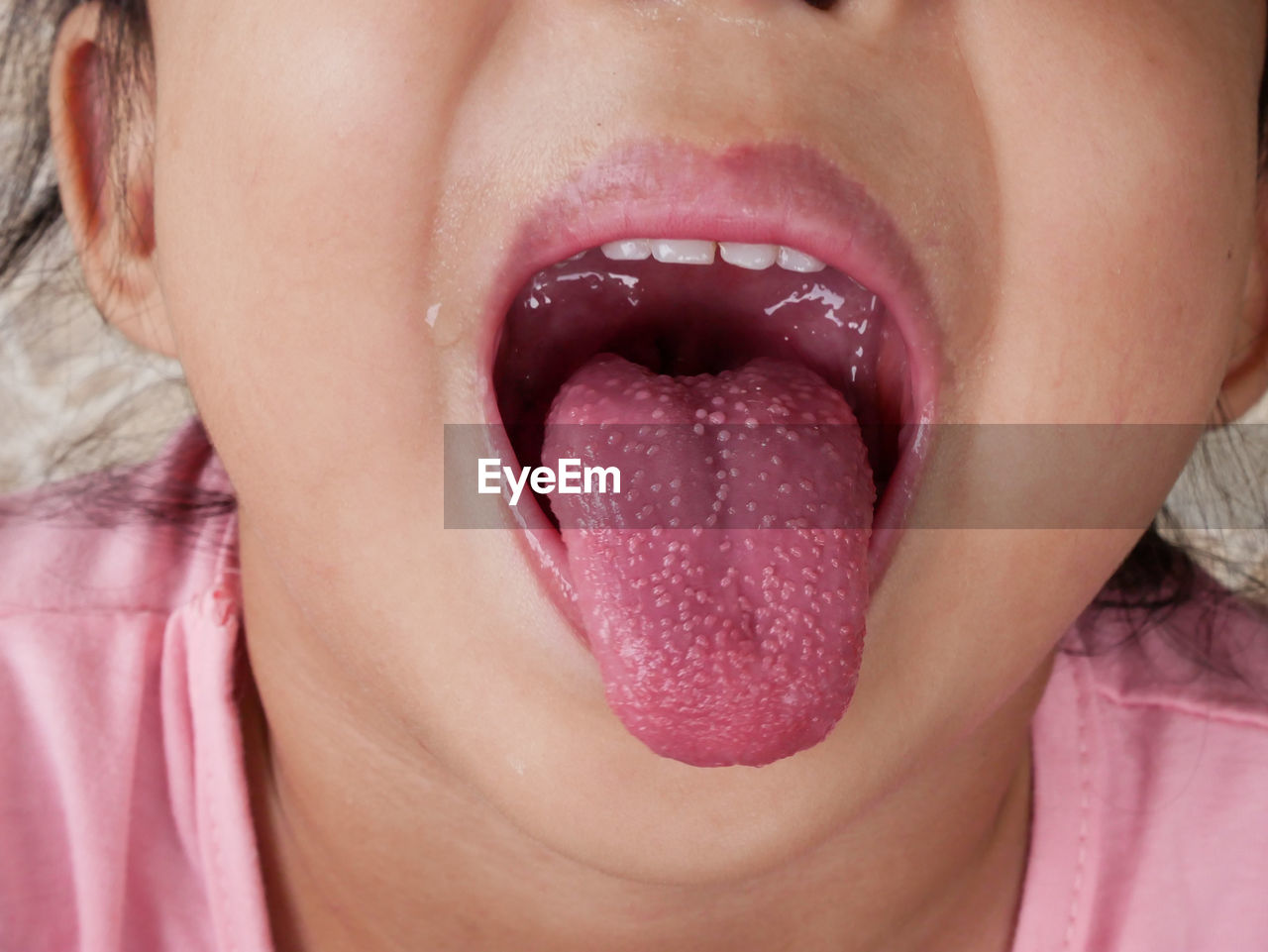 Close-up of girl showing tongue at home 