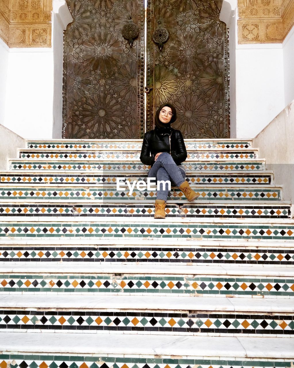 WOMAN SITTING ON STAIRCASE