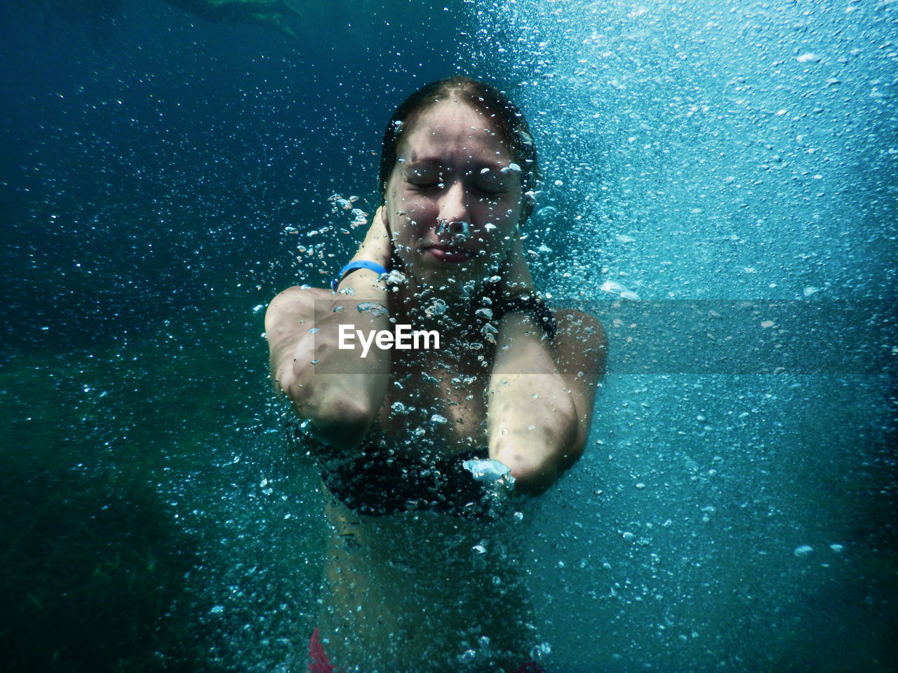 Young woman swimming in undersea