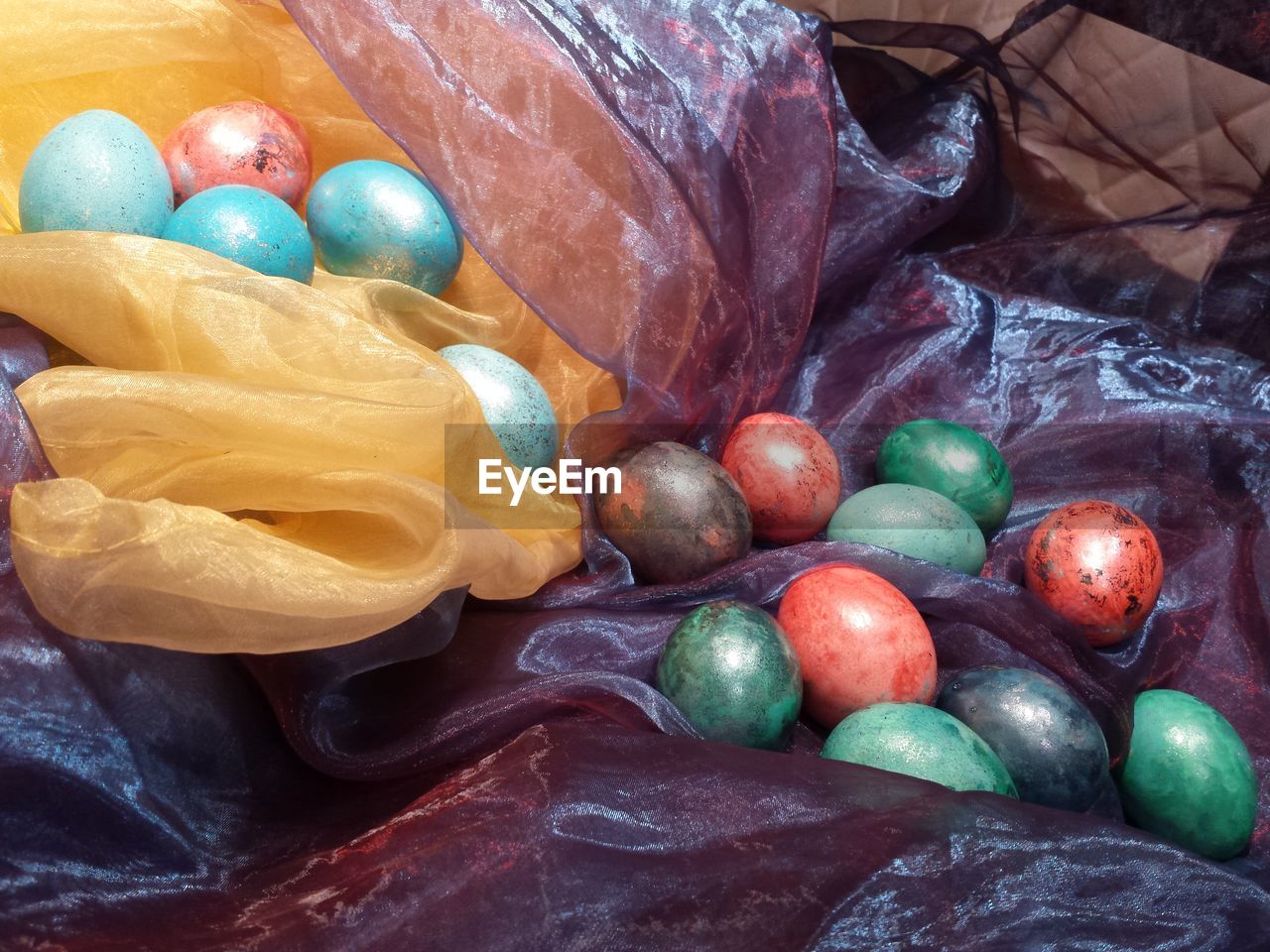 Close-up of easter eggs on colorful fabrics