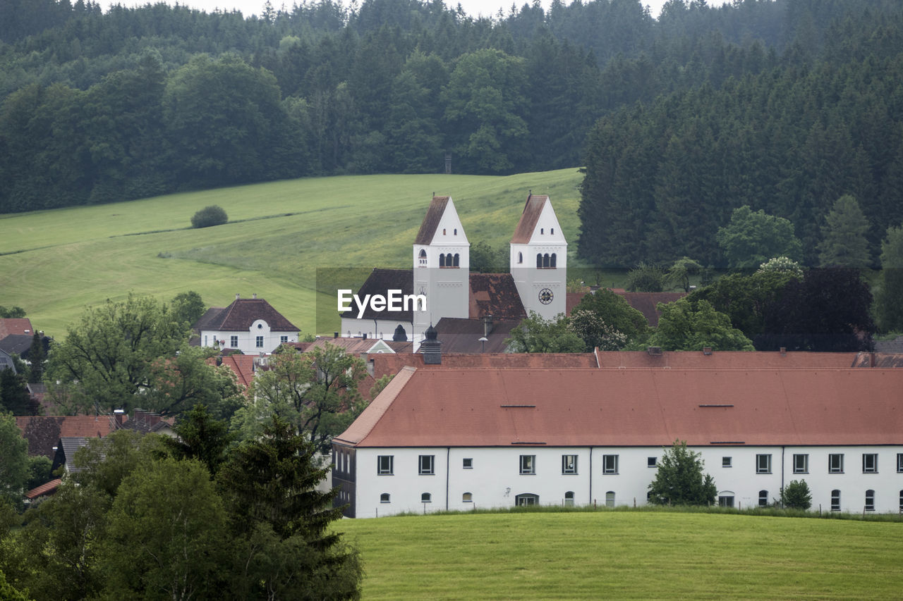 plant, architecture, built structure, tree, building exterior, building, house, grass, green, land, residential district, nature, landscape, no people, environment, place of worship, rural area, château, hill, rural scene, estate, field, the past, home, history, scenics - nature, farm, religion, mansion, lawn, outdoors, day, beauty in nature, sky, travel destinations, non-urban scene, roof, growth, foliage, tranquility, mountain range, forest, lush foliage