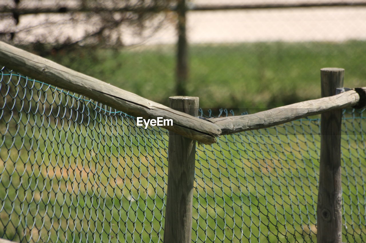 Close-up of chainlink fence on field