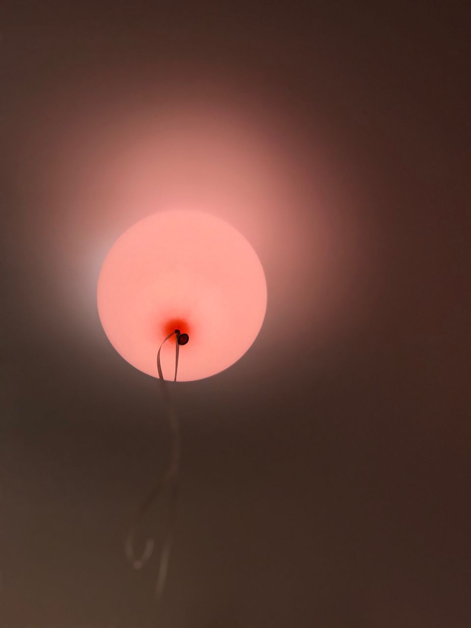 LOW ANGLE VIEW OF RED BALLOON AGAINST SKY DURING SUNSET