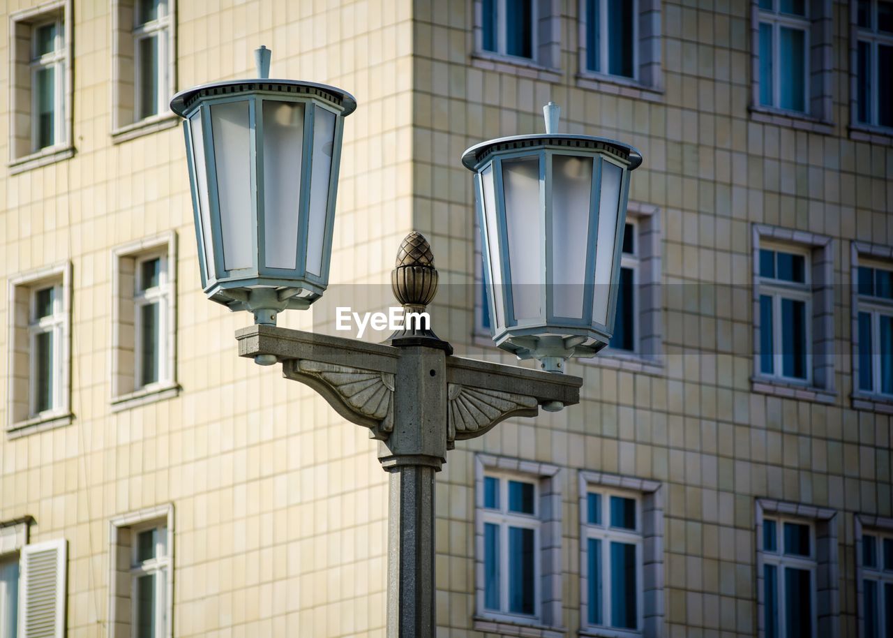 Lamp post by building in city