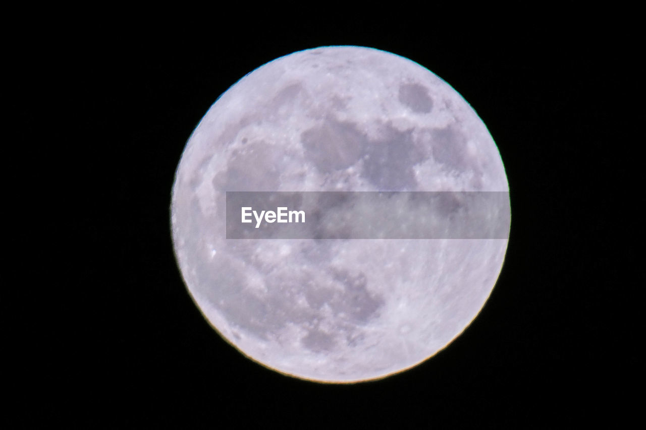 LOW ANGLE VIEW OF MOON AGAINST BLACK SKY