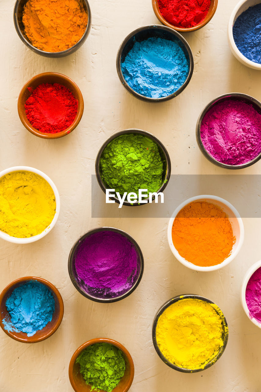 High angle view of multi colored powders on table