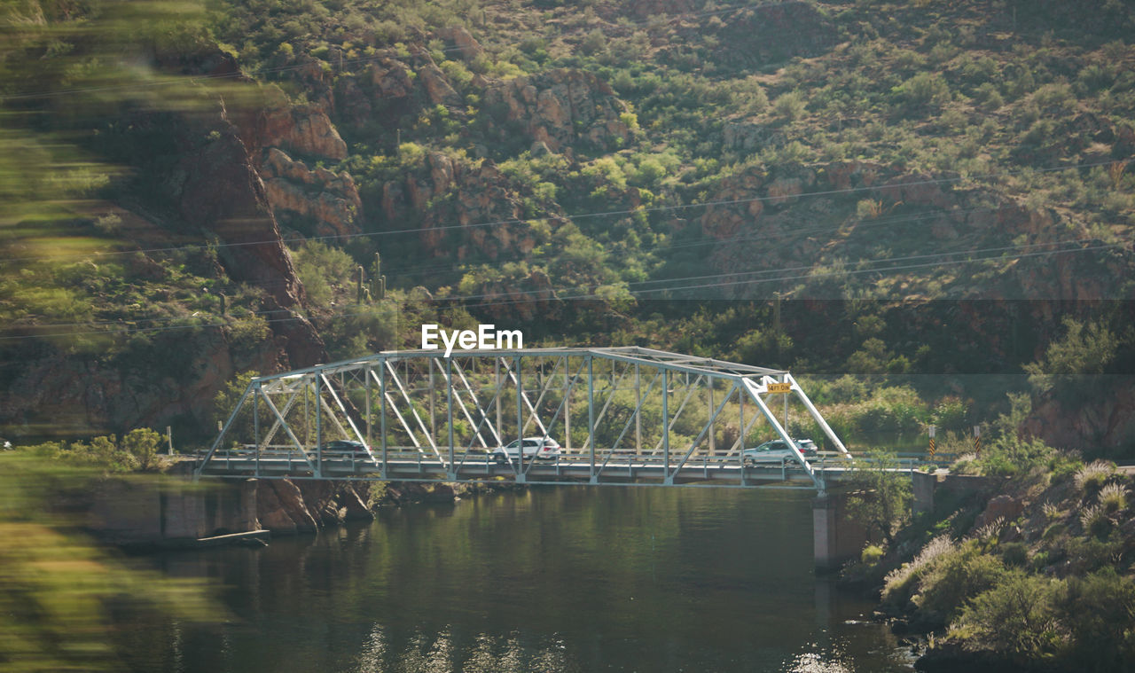 VIEW OF BRIDGE OVER RIVER IN FOREST