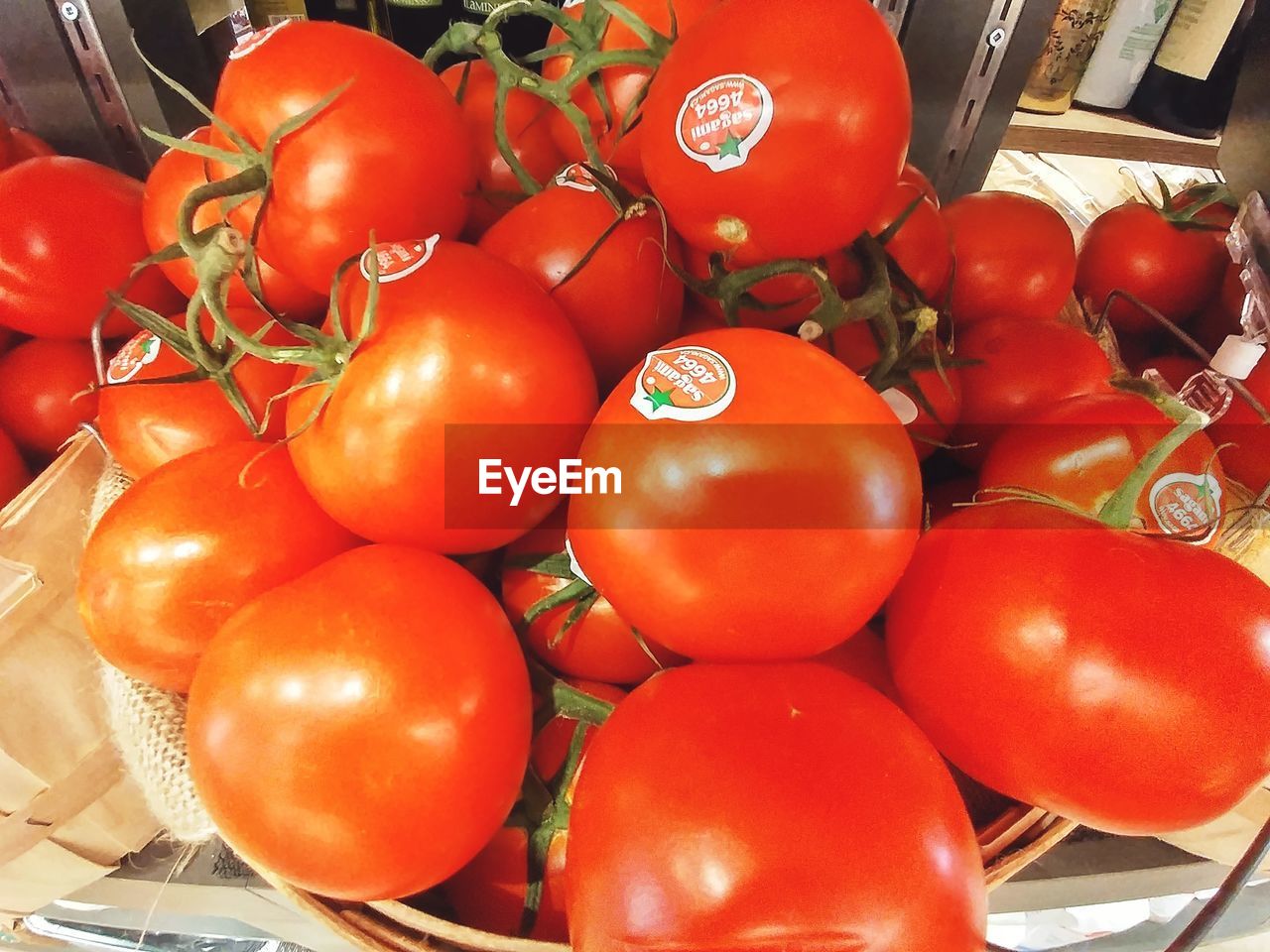 CLOSE-UP OF TOMATOES IN CONTAINER