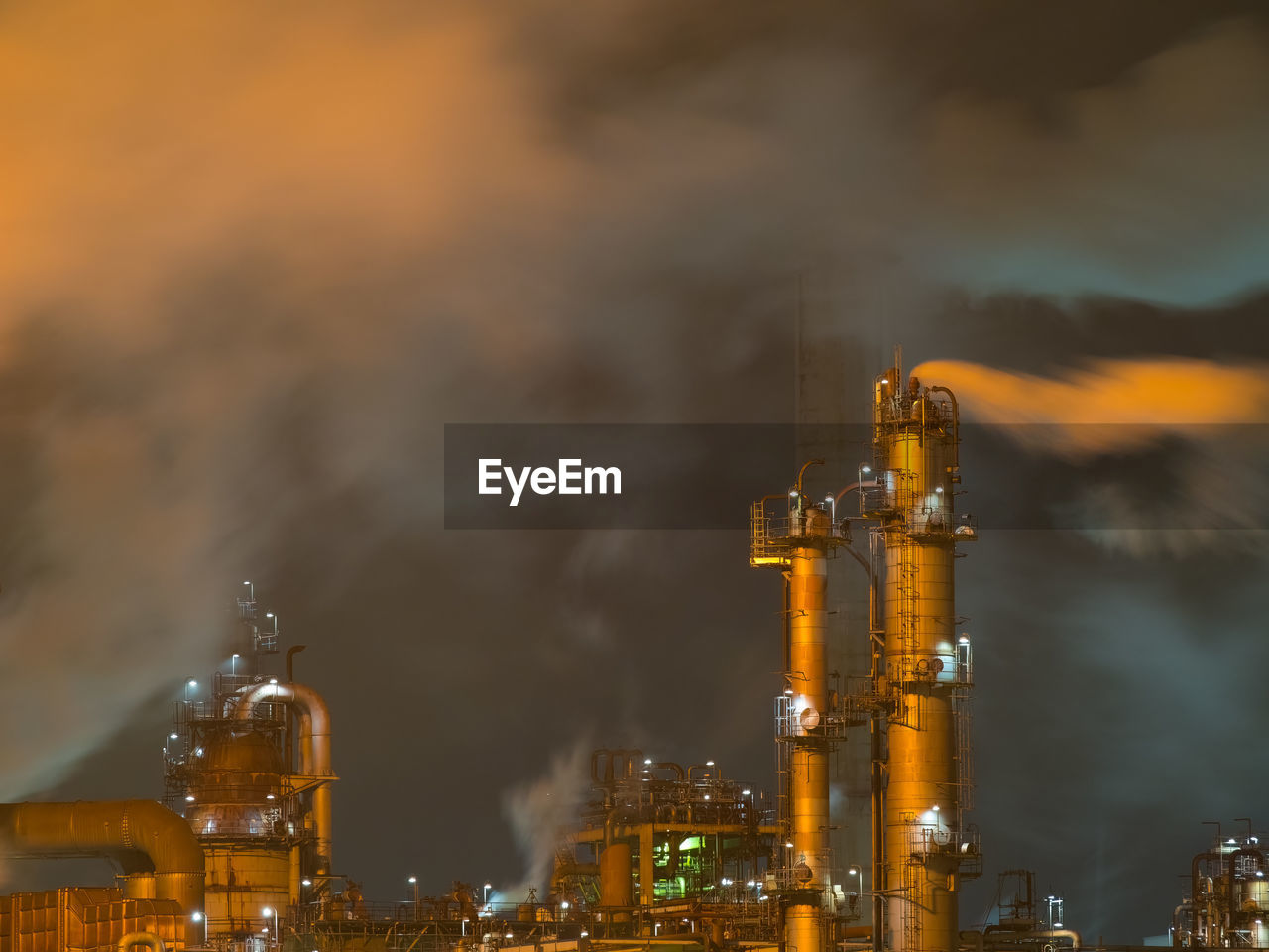 Night view of oil refinery in strong winds.