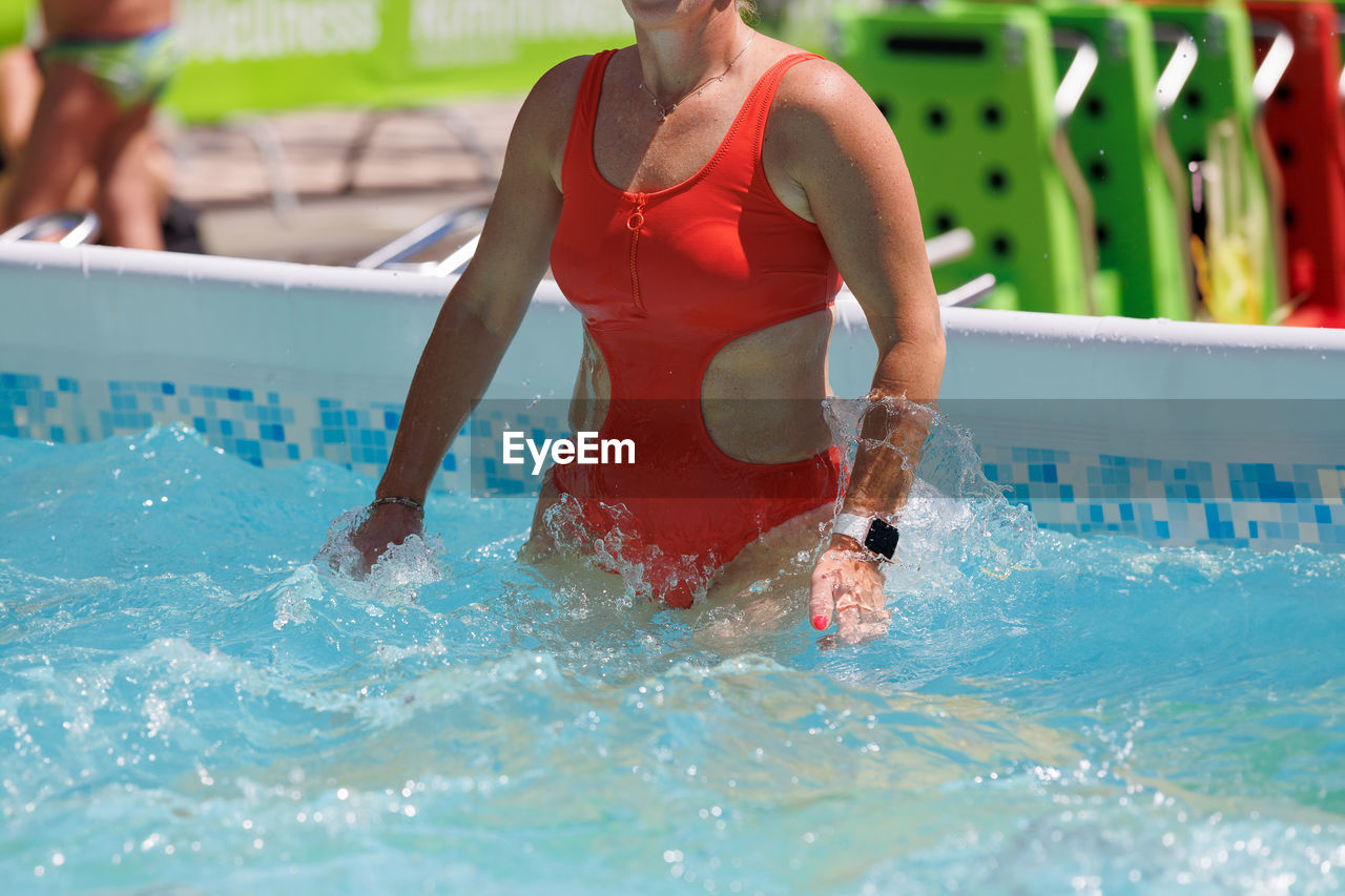 swimming pool, water, swimming, sports, adult, swimmer, lifestyles, water sports, clothing, exercising, nature, splashing, competition, motion, day, athlete, leisure activity, men, recreation, swimwear, women, summer, vitality, endurance sports, female, two people, fun, enjoyment, outdoors, front view, swimming cap, emotion, young adult, wet, mature adult, competitive sport, happiness, determination