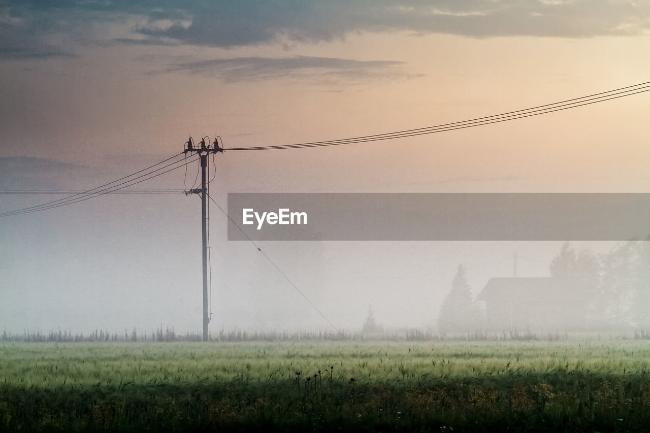 Telephone lines in the misty sunset