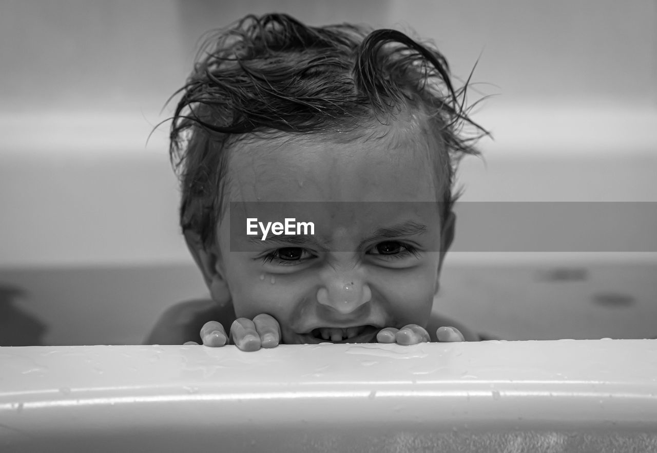 Boy plays in the bath tub. 