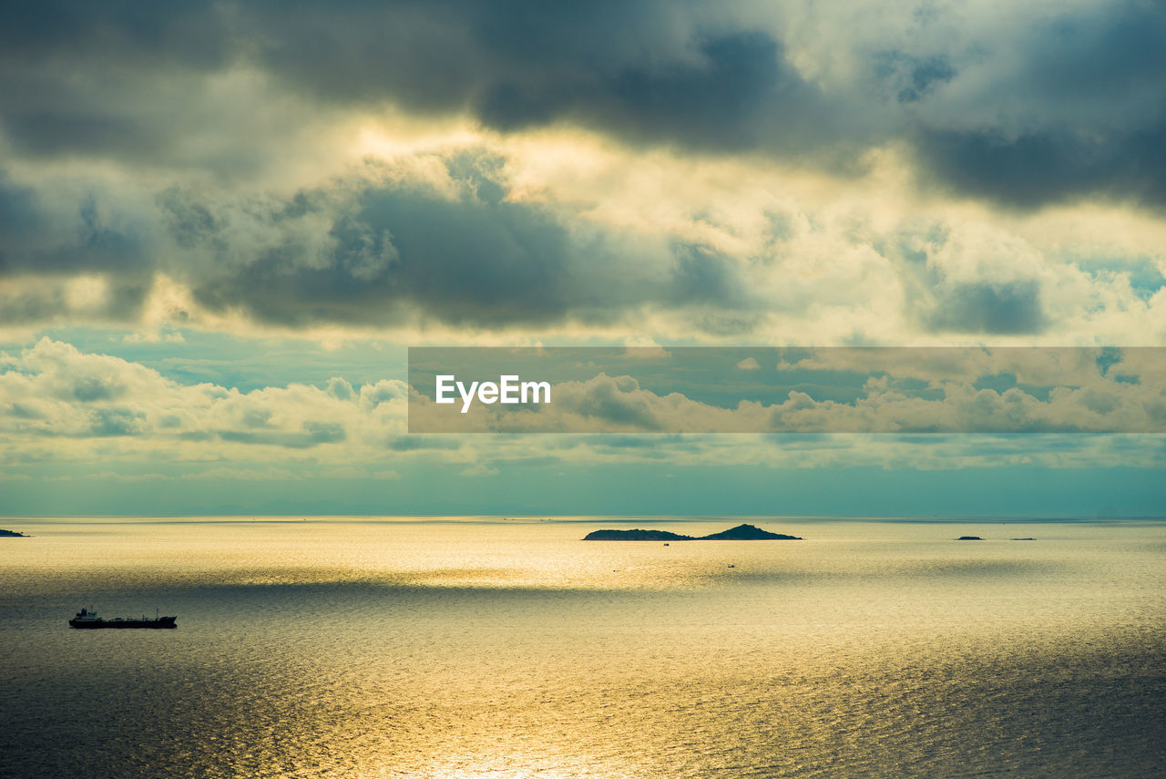 SCENIC VIEW OF BEACH AGAINST CLOUDY SKY