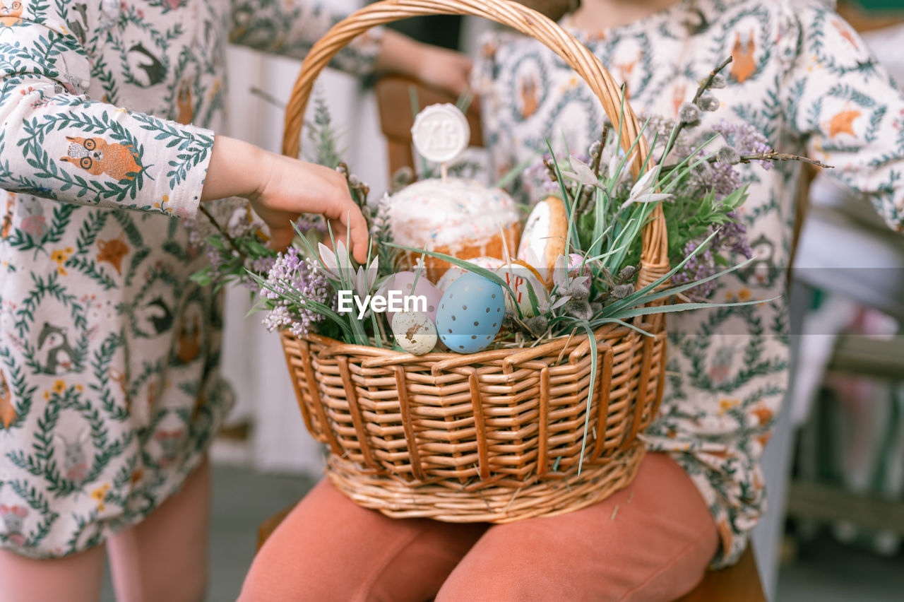 basket, easter, spring, picnic basket, women, gift basket, adult, celebration, container, tradition, holding, wicker, easter egg, egg, plant, midsection, food, flower, nature, food and drink, pattern, one person, flowering plant, female, lifestyles, event, floral pattern, floristry, decoration, holiday, focus on foreground, freshness, outdoors, day, hamper, hand