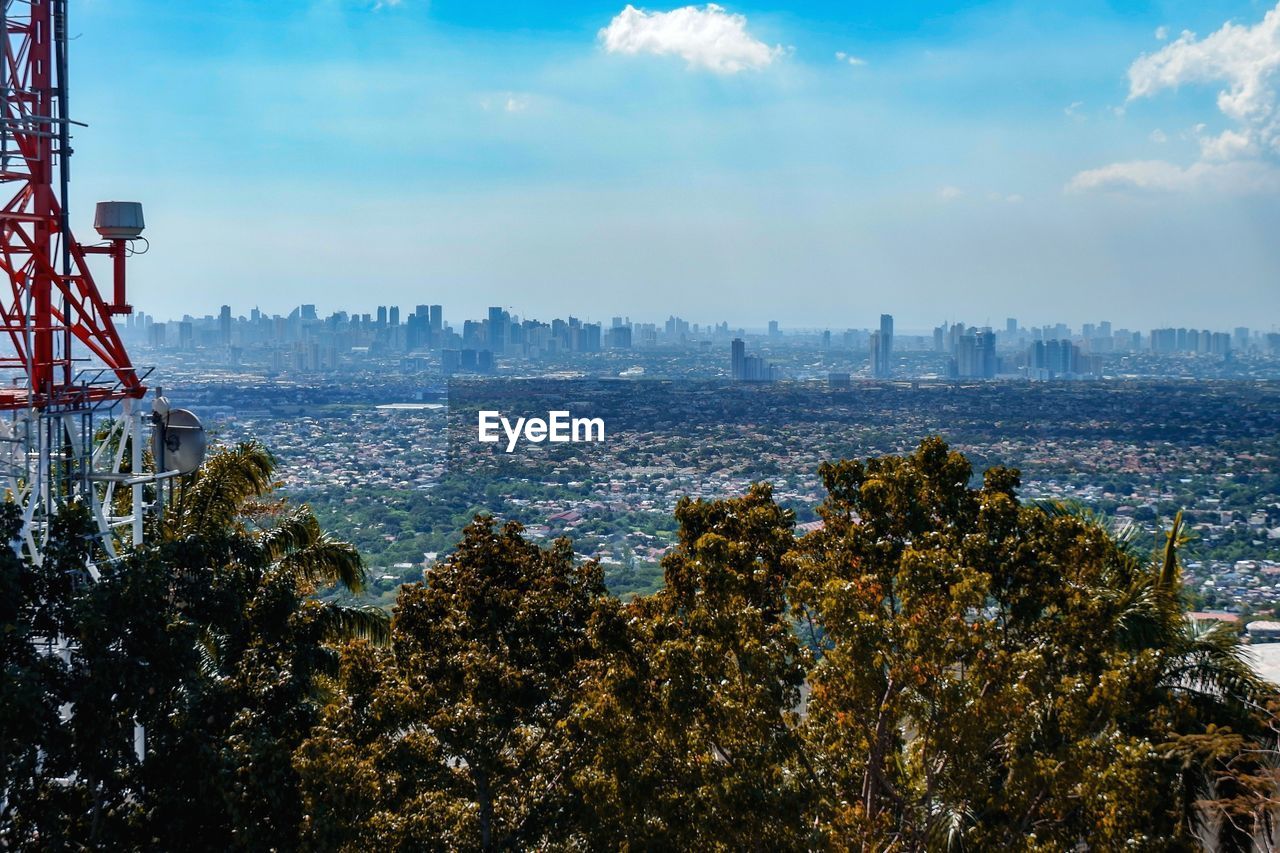 Scenic view of sea and cityscape against sky