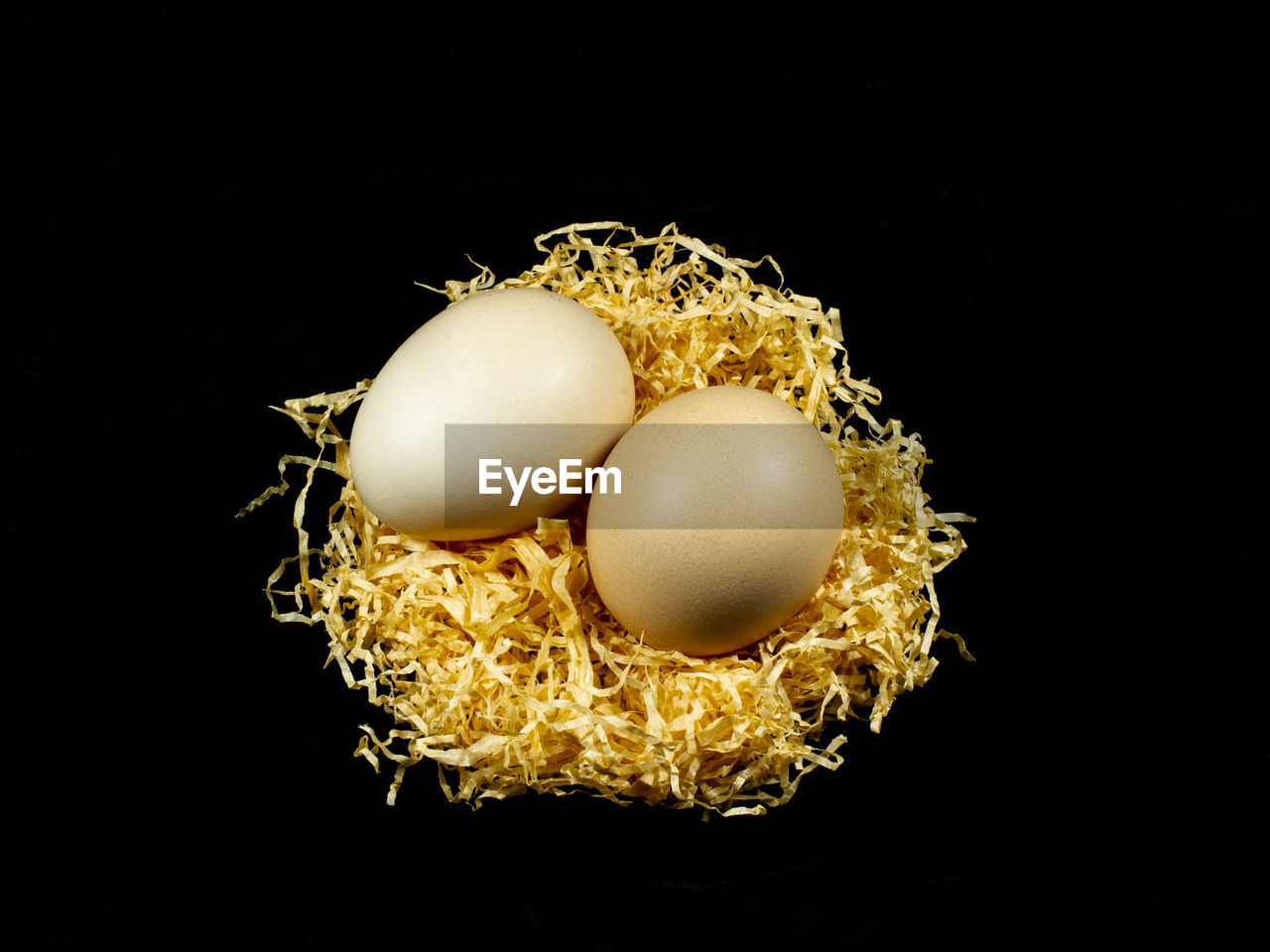 Close-up of eggs against black background