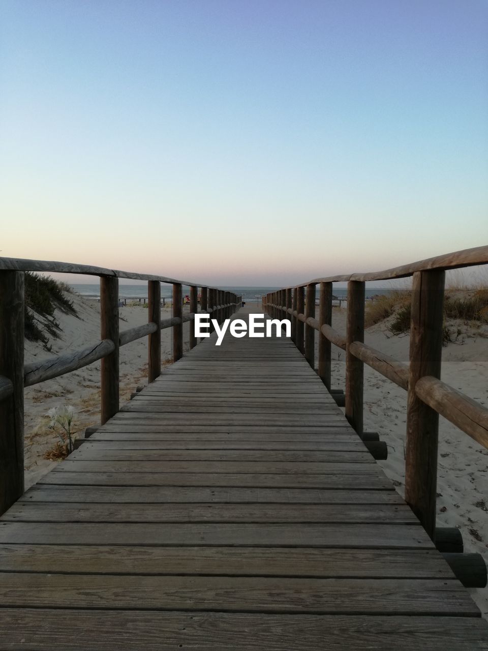 Pier on sea against clear sky