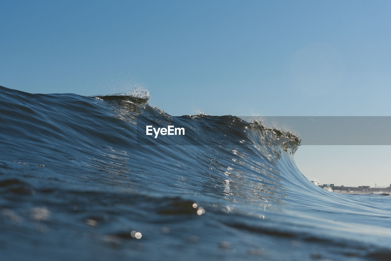 Scenic view of sea against clear blue sky