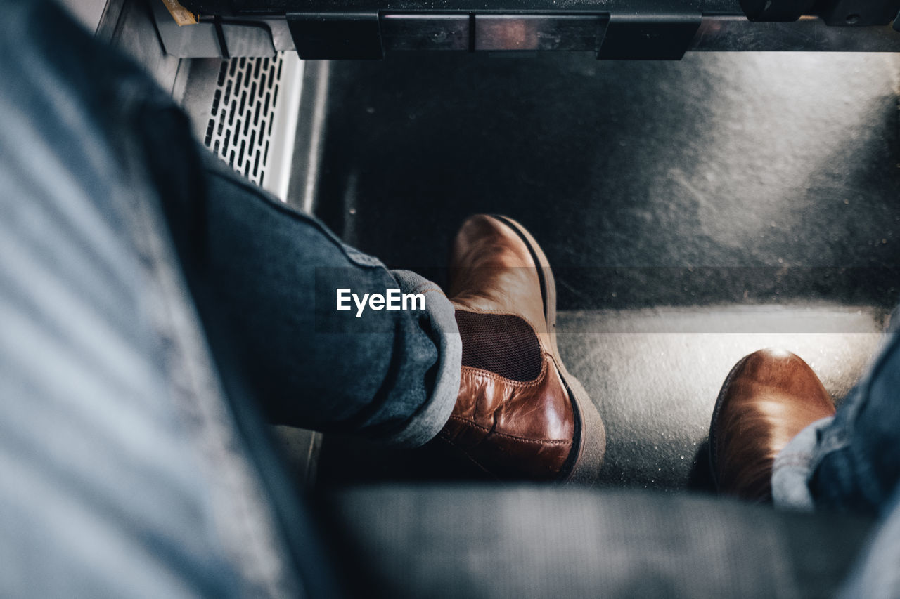 black, low section, men, human leg, one person, adult, shoe, personal perspective, indoors, human limb, lifestyles, limb, selective focus, casual clothing, close-up, transportation, leisure activity