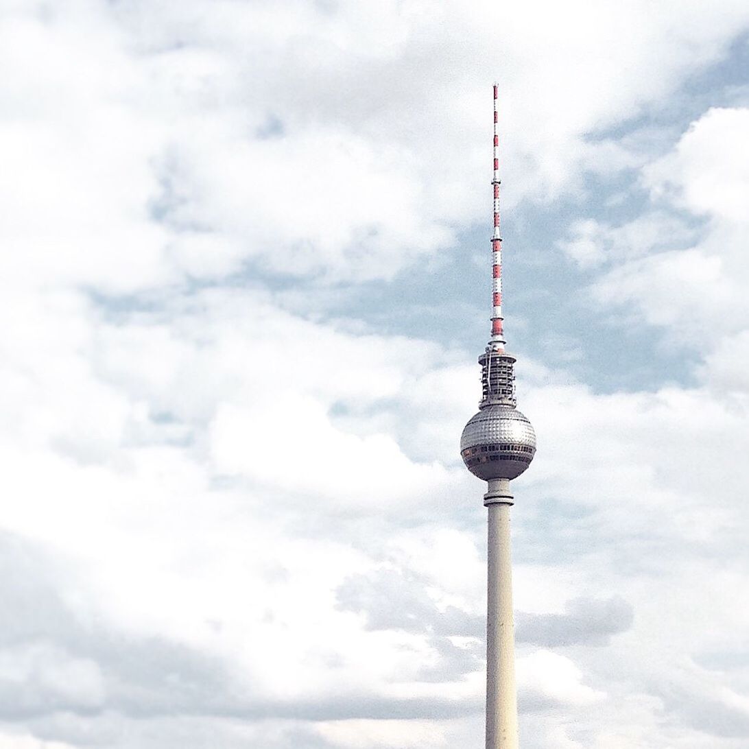 Low angle view of tv tower against cloudy sky