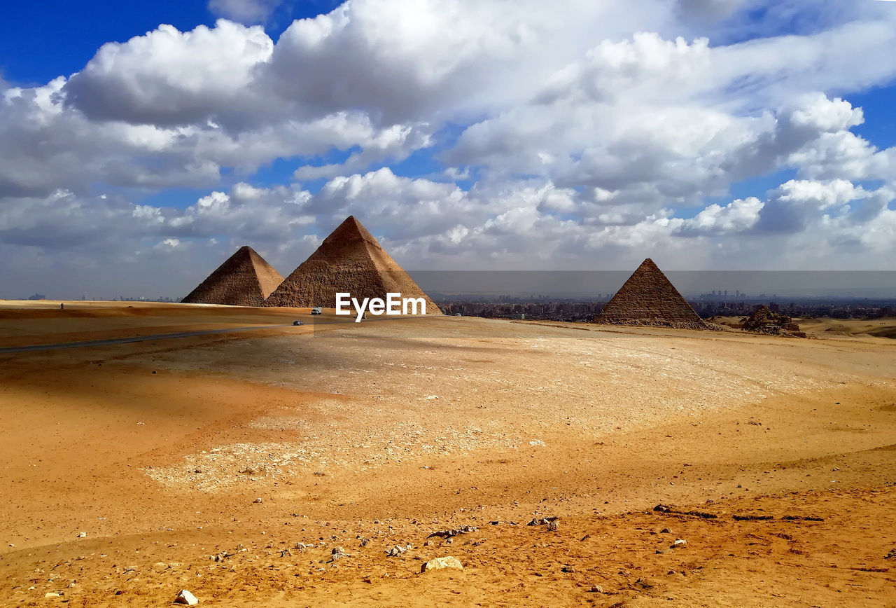 Built structure on desert against cloudy sky