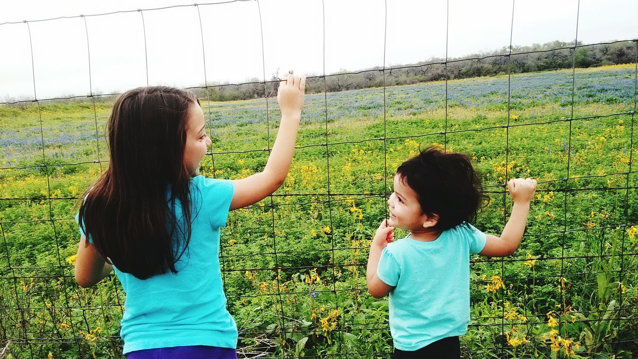 Rear view of little girls looking at each other