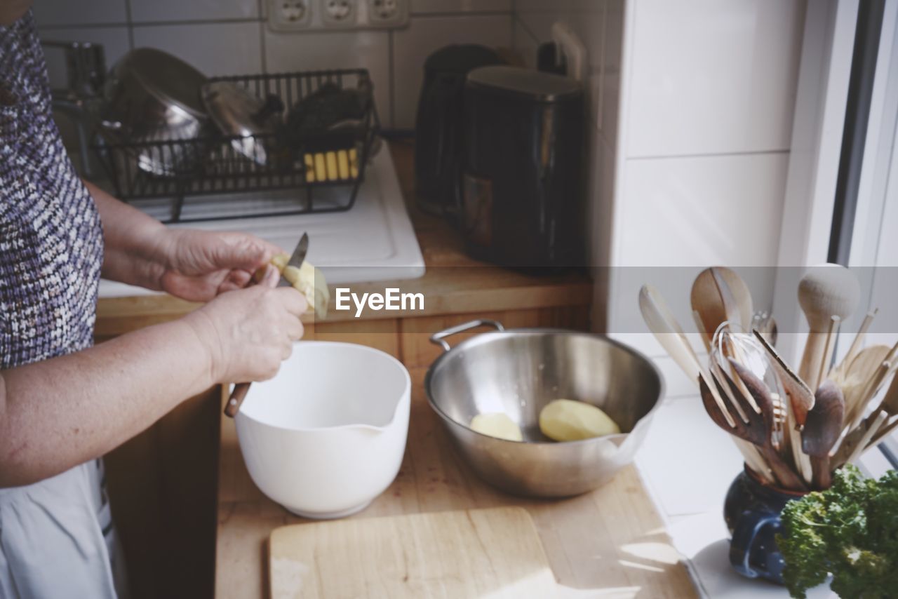 Woman peeling potatoes