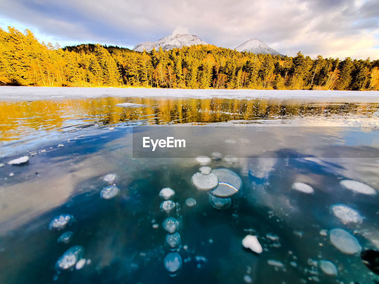 Scenic view of crystal frozen lake with ice bubbles