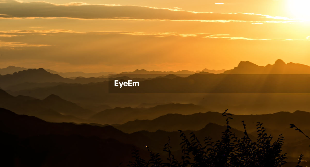 Scenic view of silhouette mountains against sky during sunset