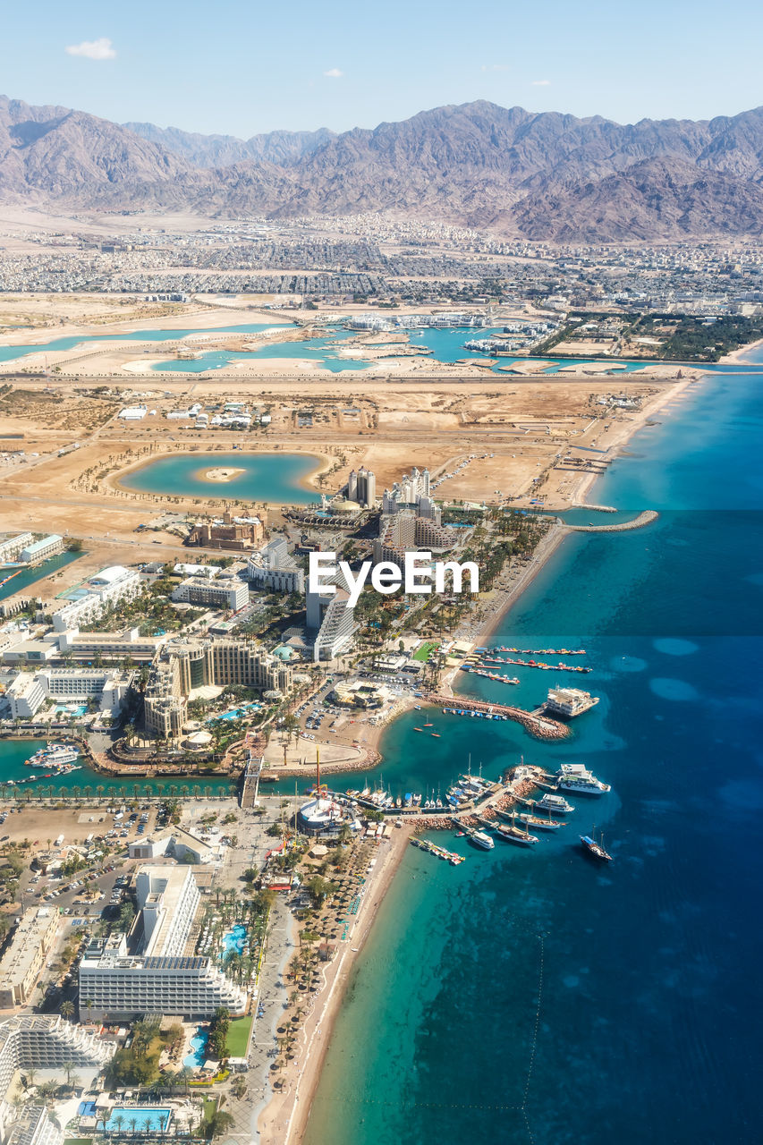 HIGH ANGLE VIEW OF CITY AT SEASIDE