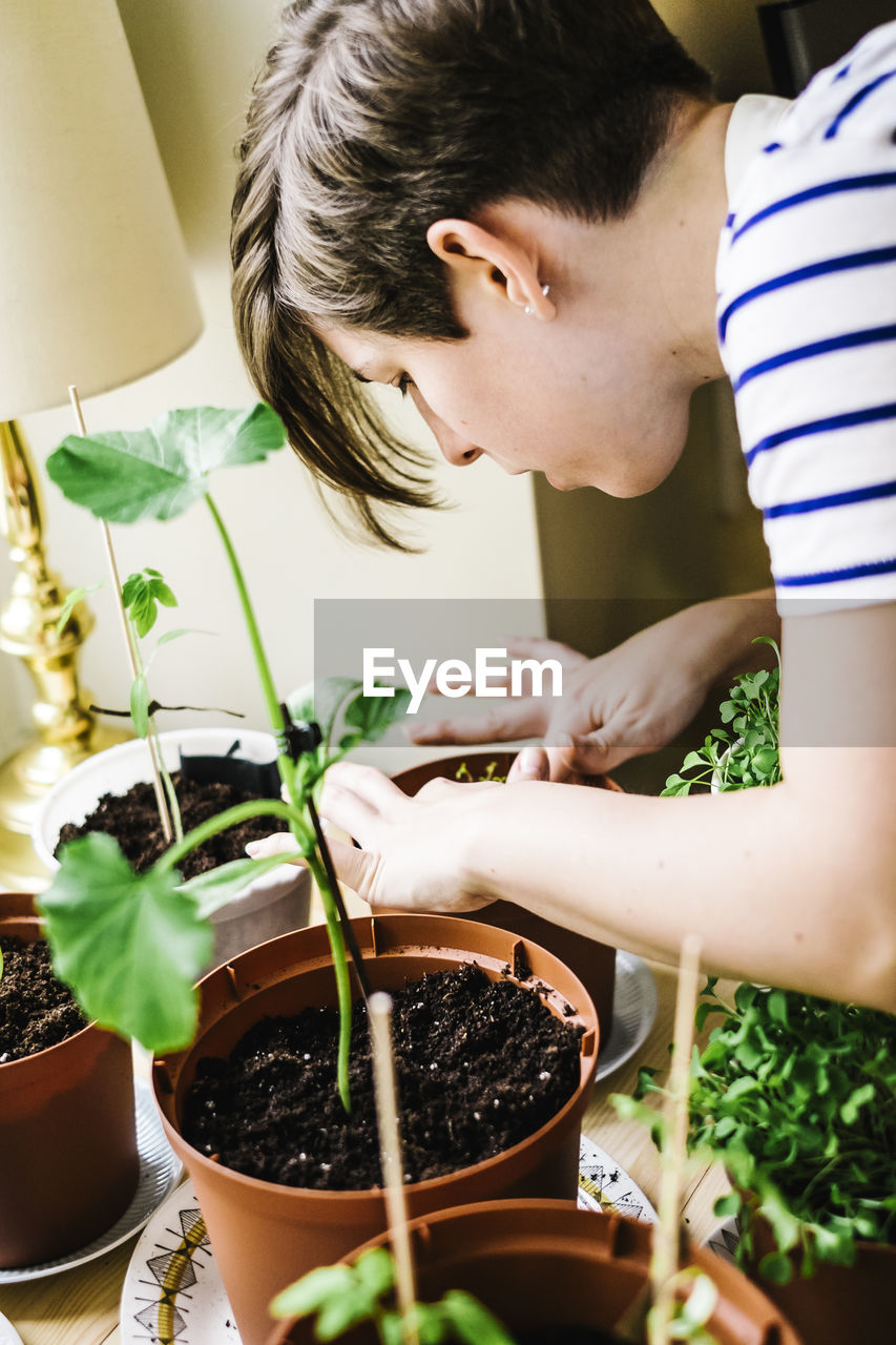 Young woman tying plant