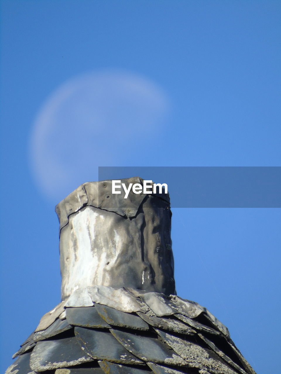 Low angle view of statue against blue sky