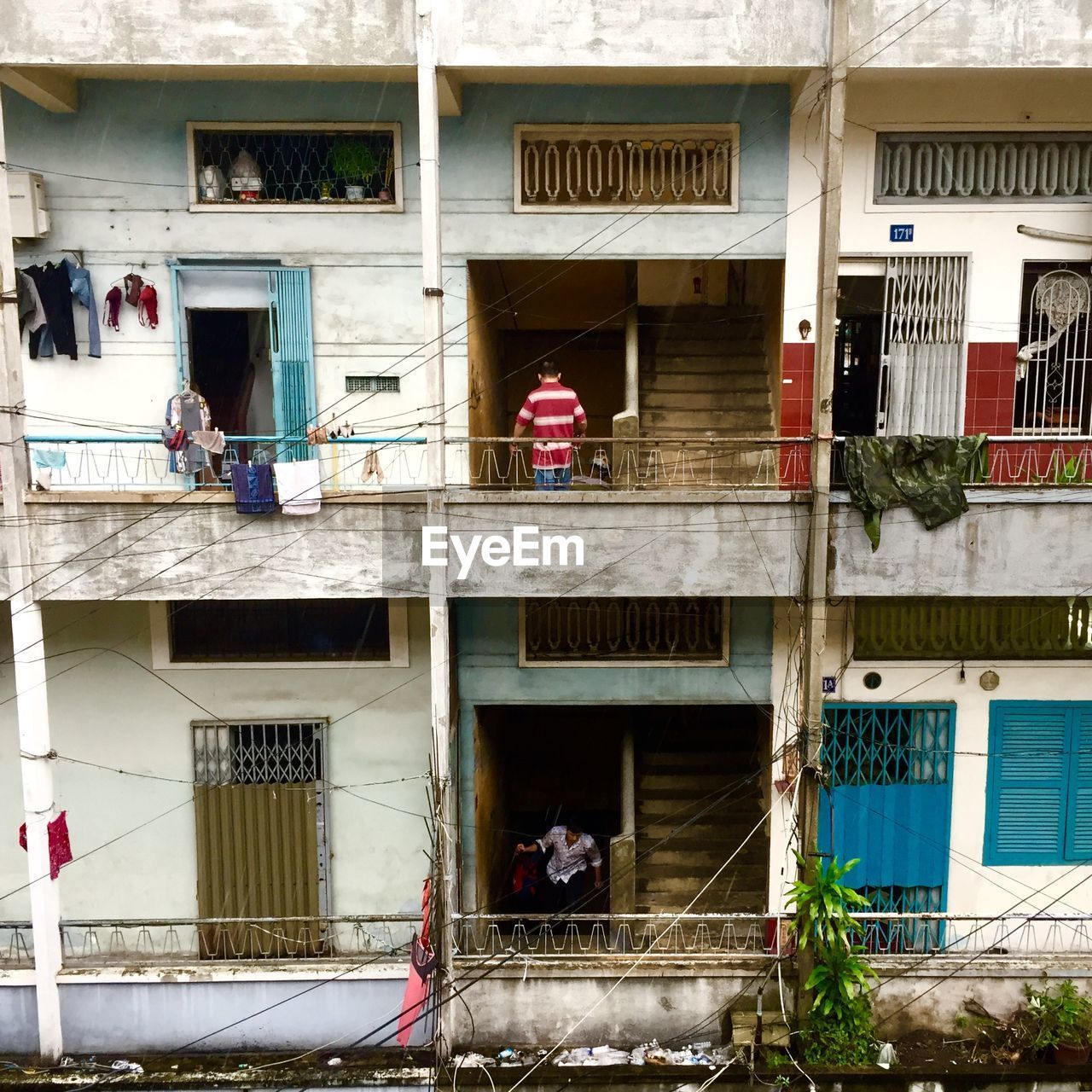 PEOPLE ON STREET AGAINST BUILDING