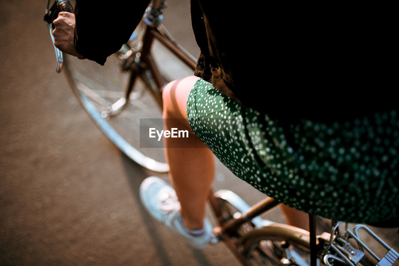 Midsection of woman riding bicycle