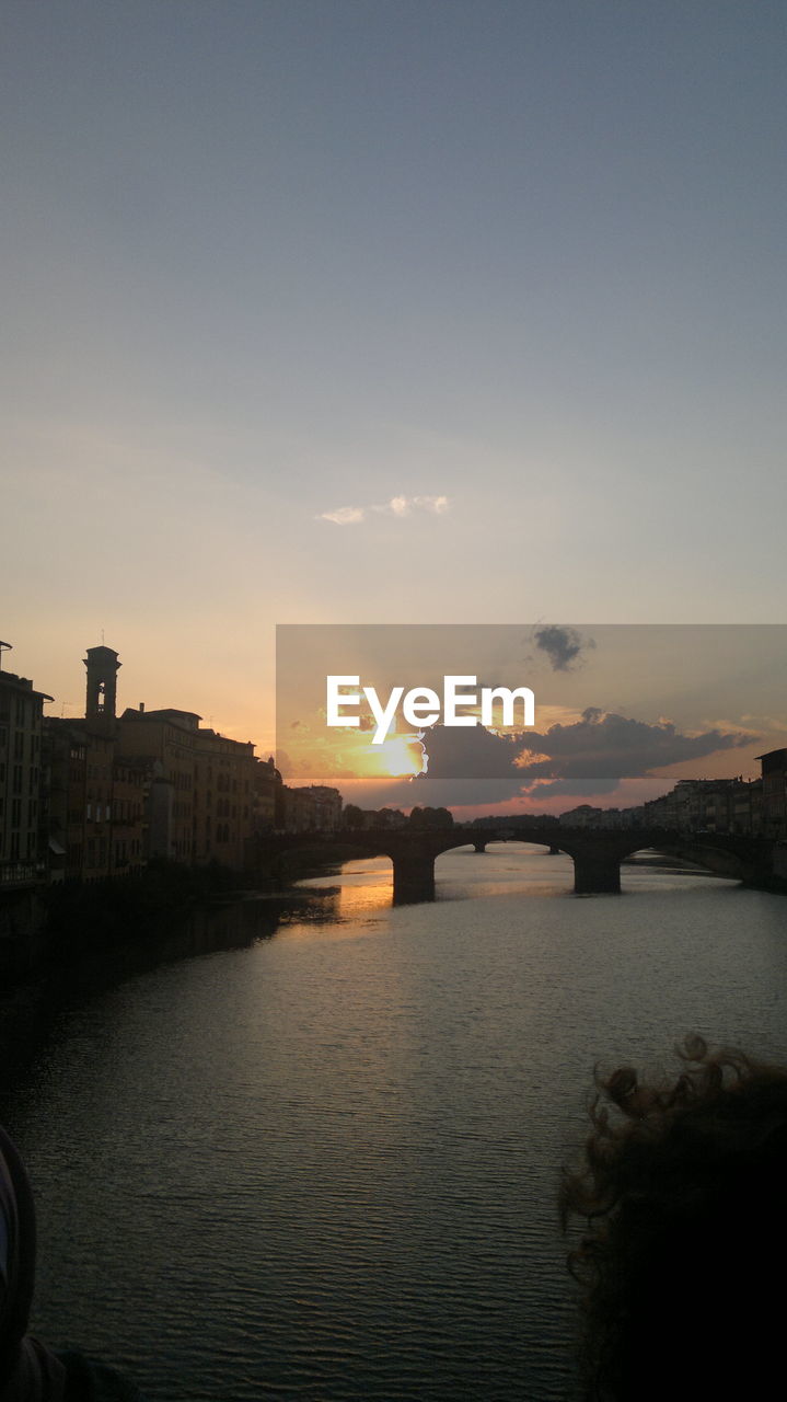 VIEW OF RIVER WITH BUILDINGS IN BACKGROUND