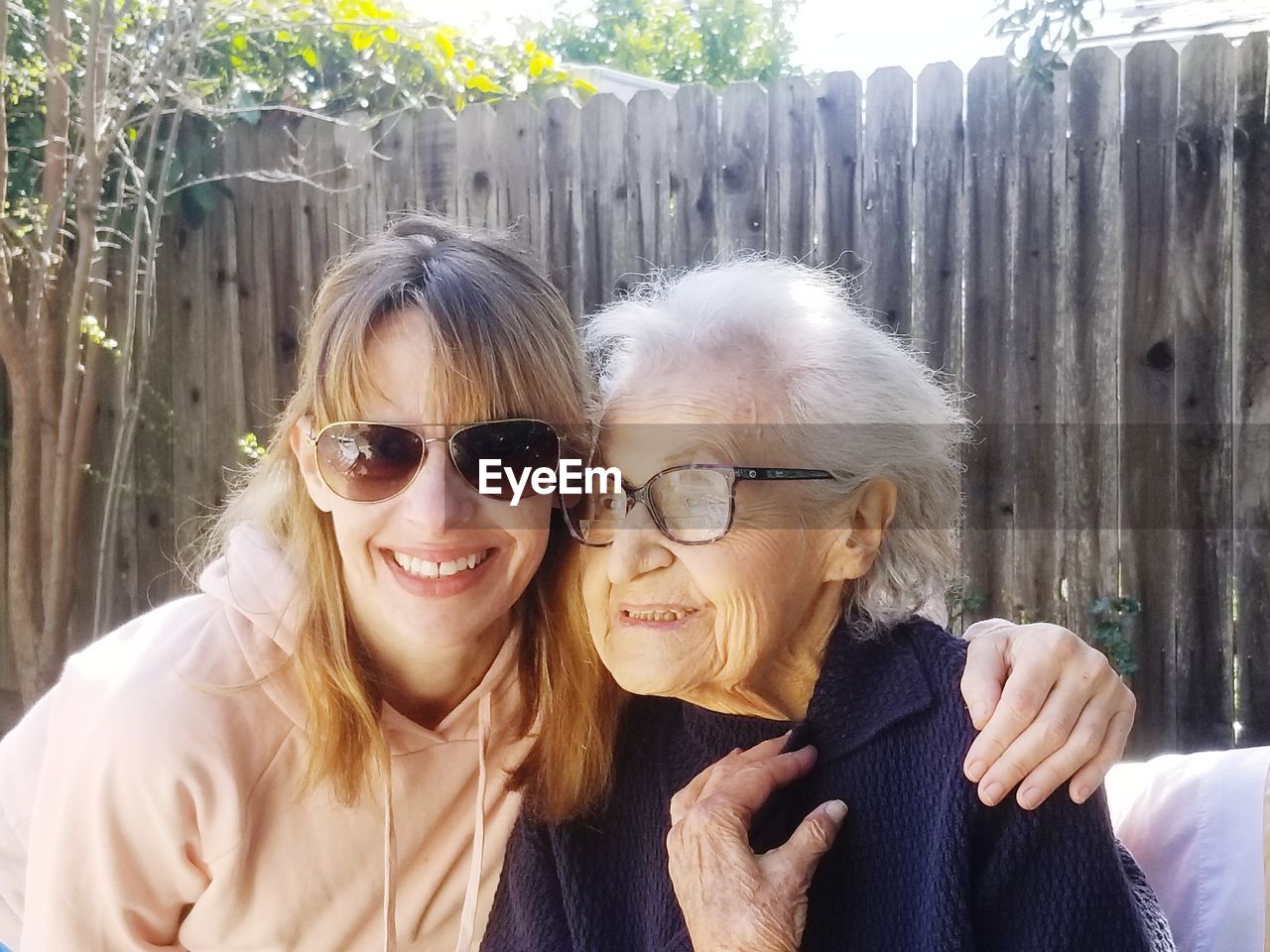 Portrait of smiling woman with mother outdoors