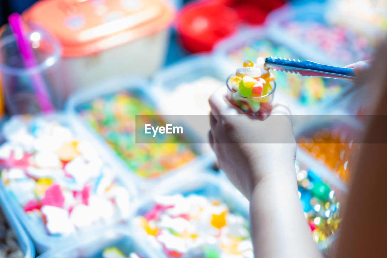 hand, multi colored, one person, holding, food, brush, paint, selective focus, food and drink, close-up, paintbrush, sweet, sweetness, indoors, sweet food, creativity, dessert, childhood, celebration, party, palette, child, adult