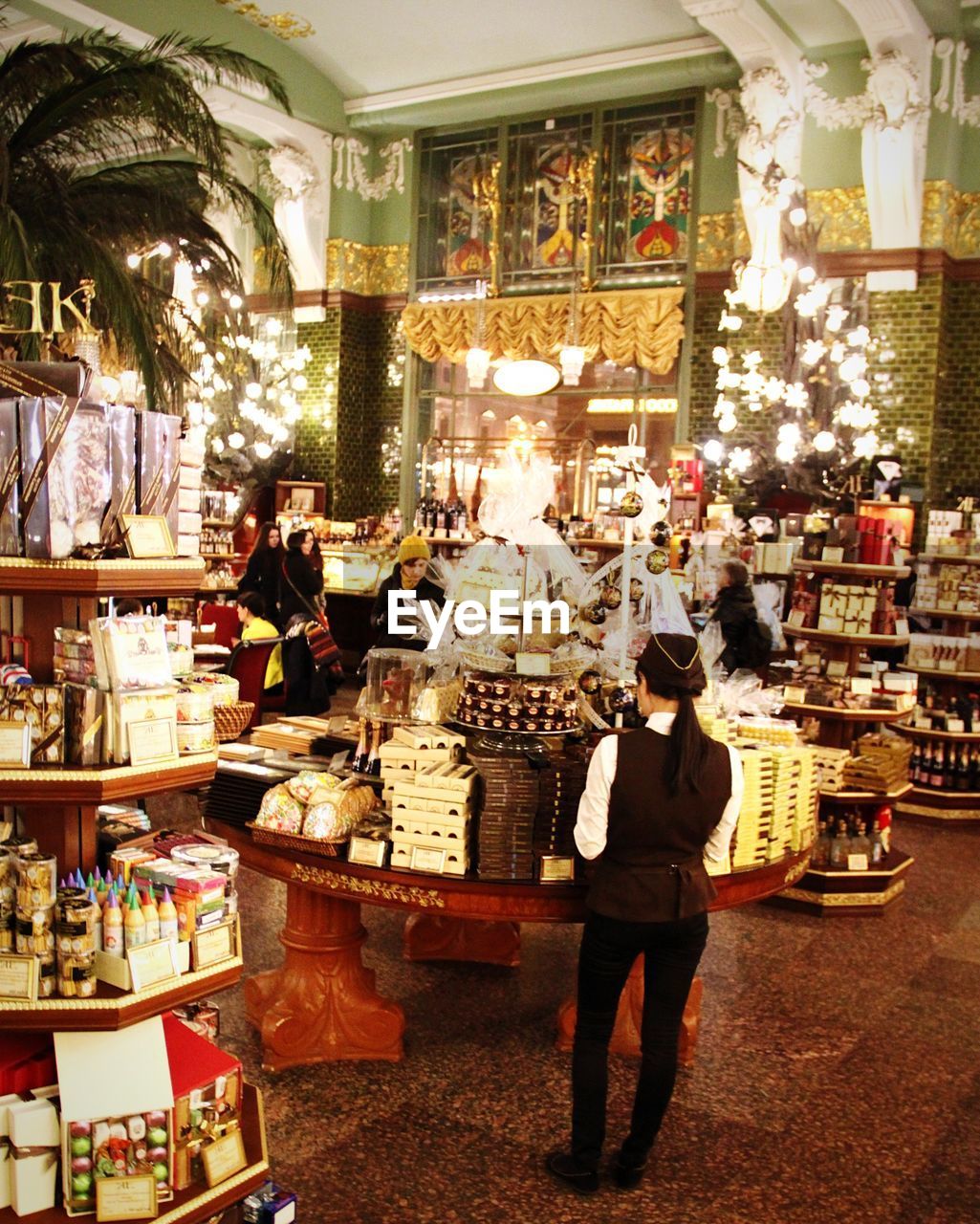 WOMAN STANDING AT STORE