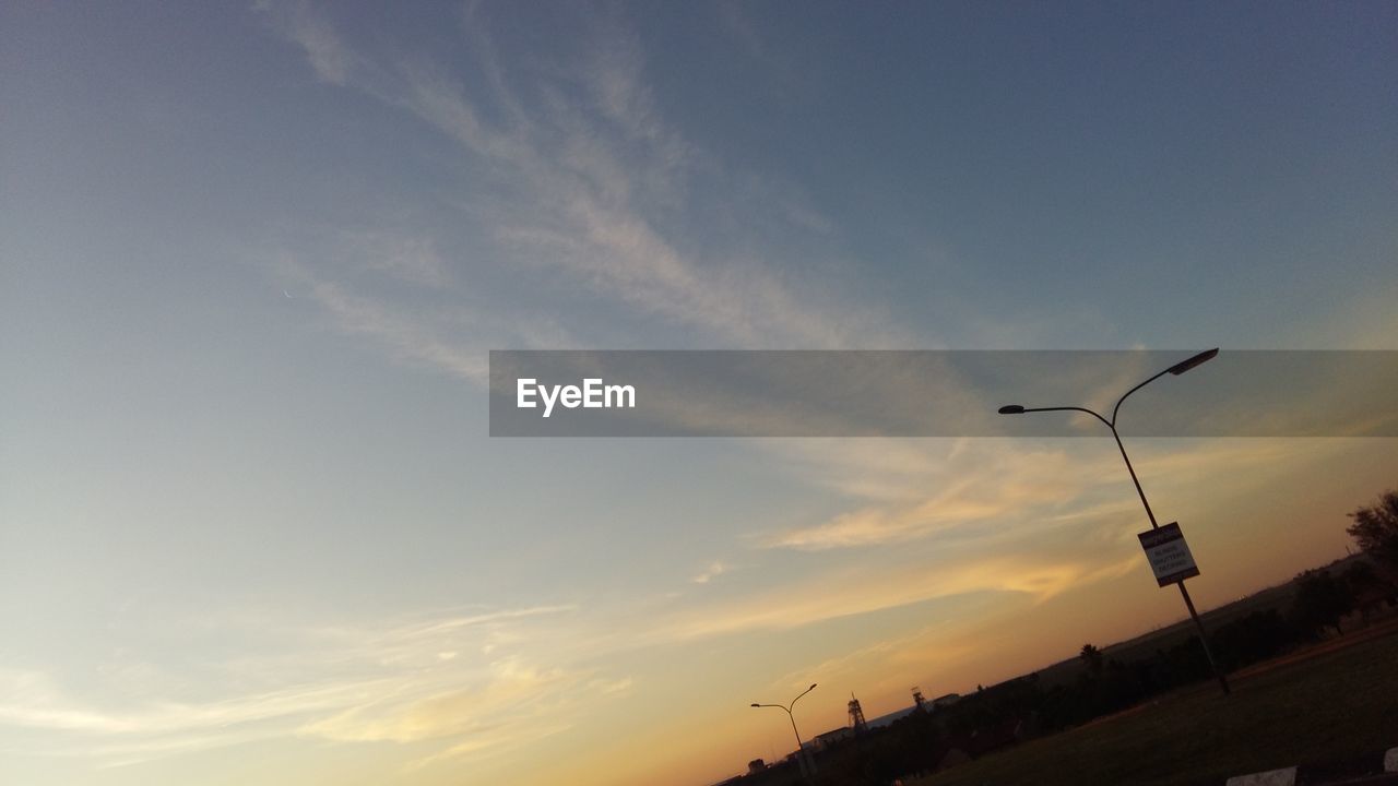 LOW ANGLE VIEW OF STREET LIGHTS AGAINST SKY