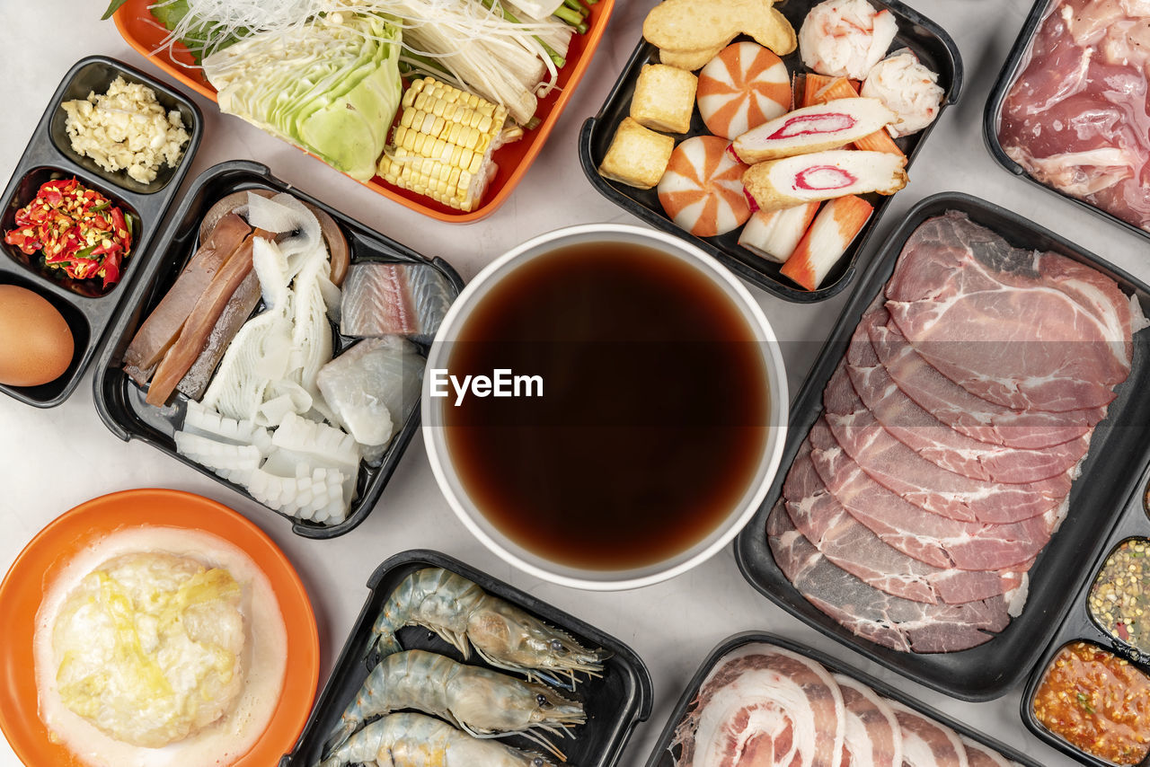 HIGH ANGLE VIEW OF FISH WITH VEGETABLES ON TABLE