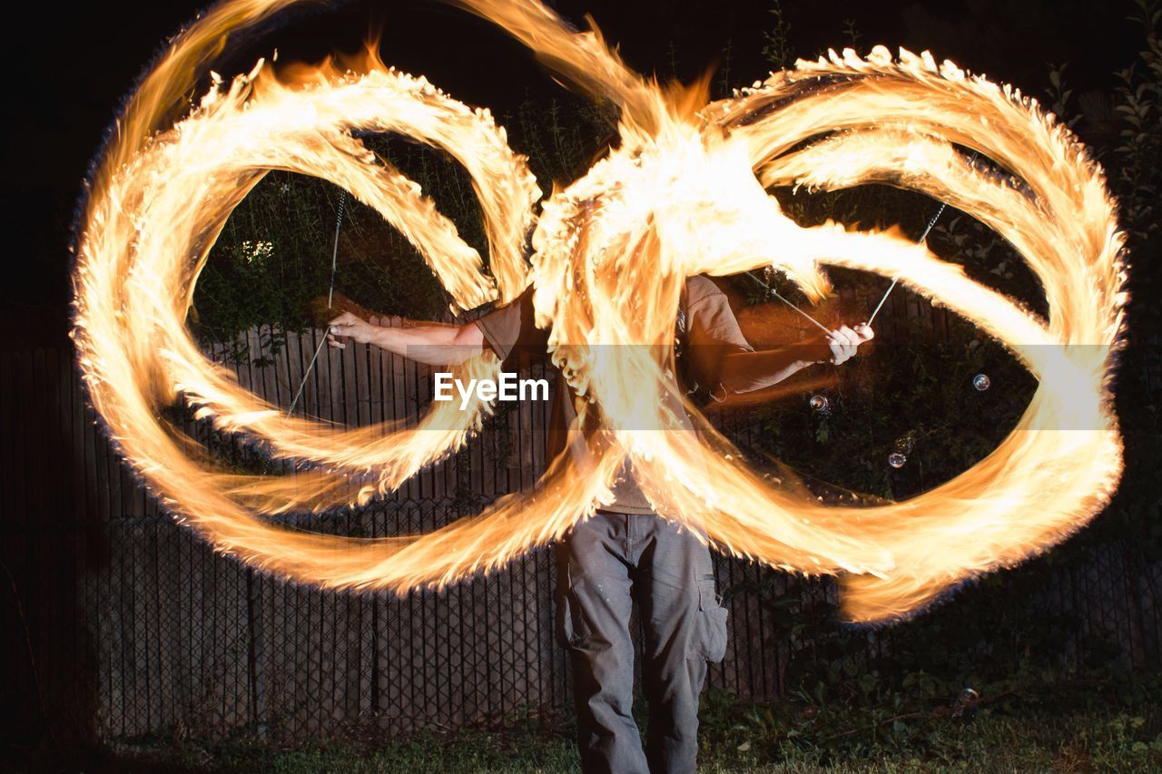 Blurred motion of man standing at night