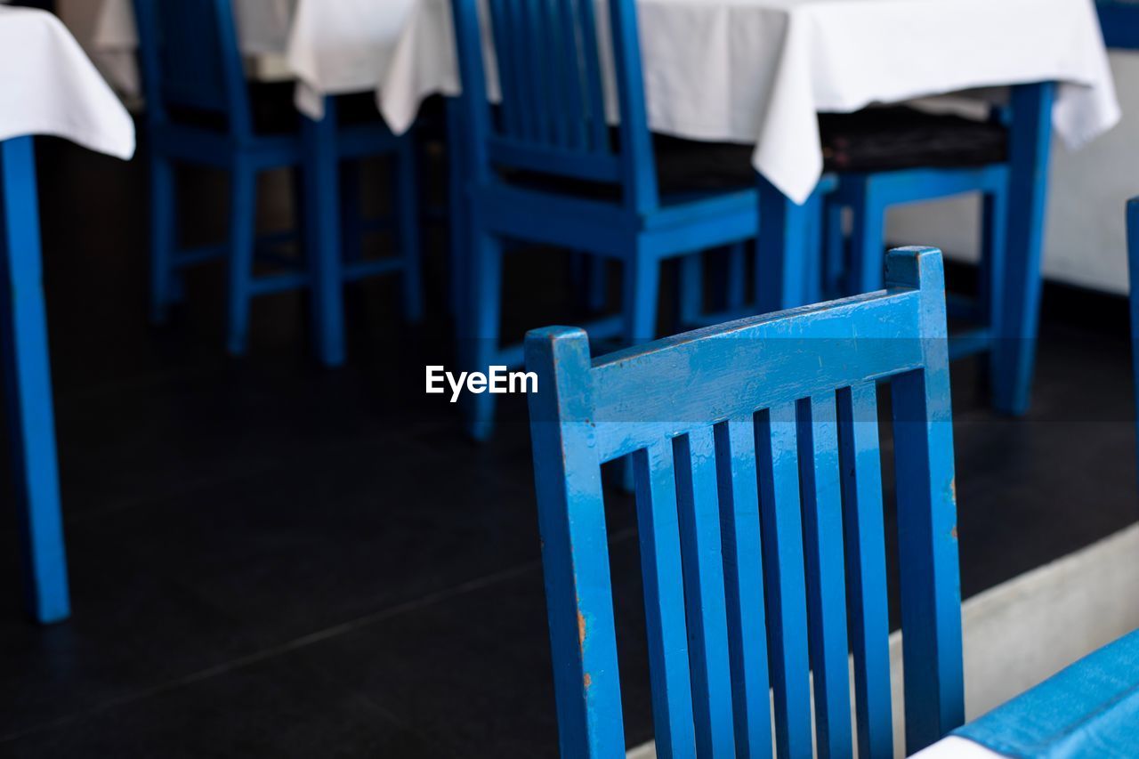 CLOSE-UP OF EMPTY CHAIRS AND TABLES