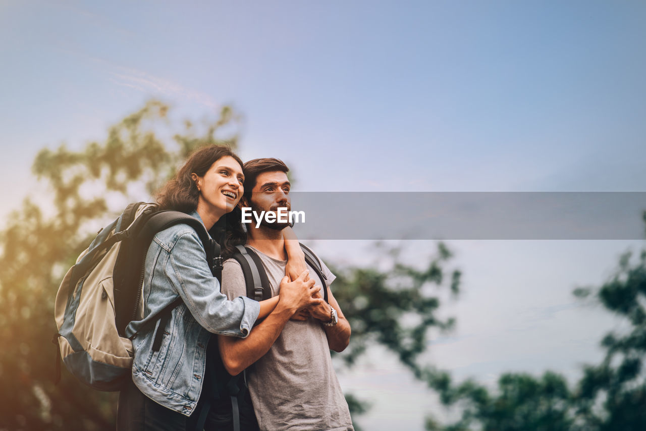 Young couple looking away while enjoying outdoors