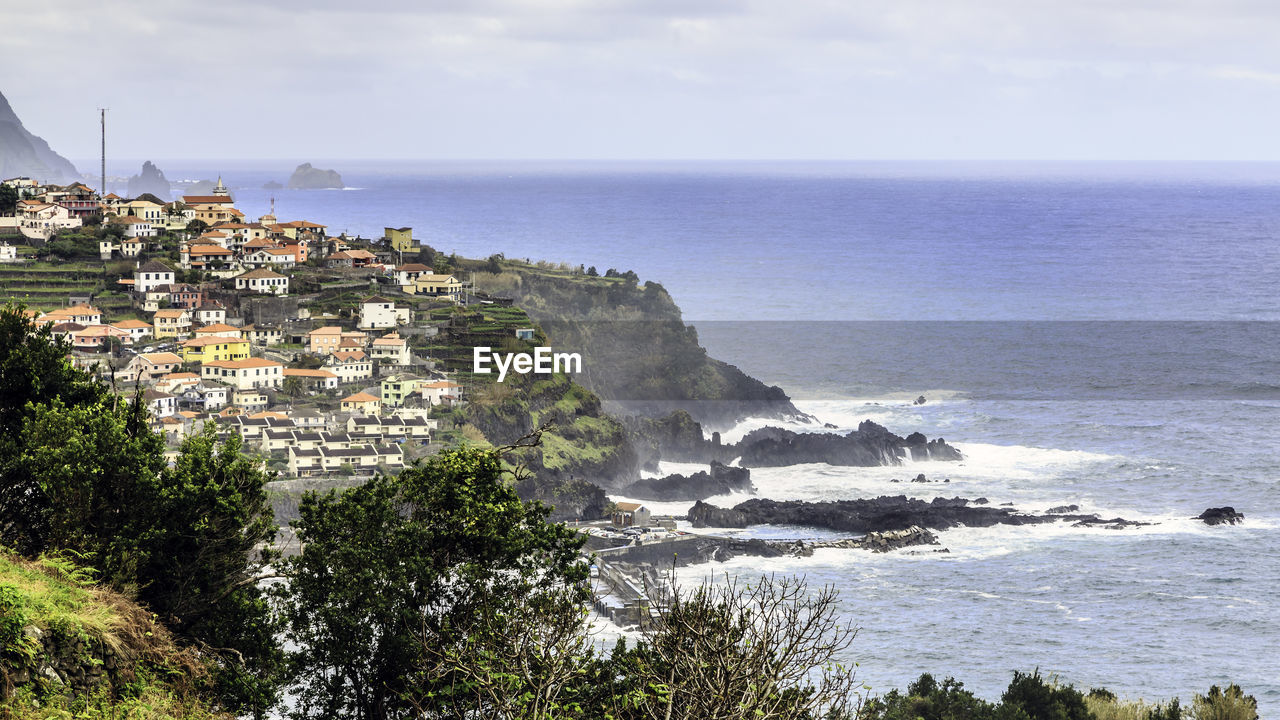 Scenic view of buildings by sea