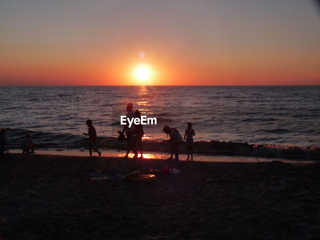 SILHOUETTE PEOPLE AT BEACH DURING SUNSET