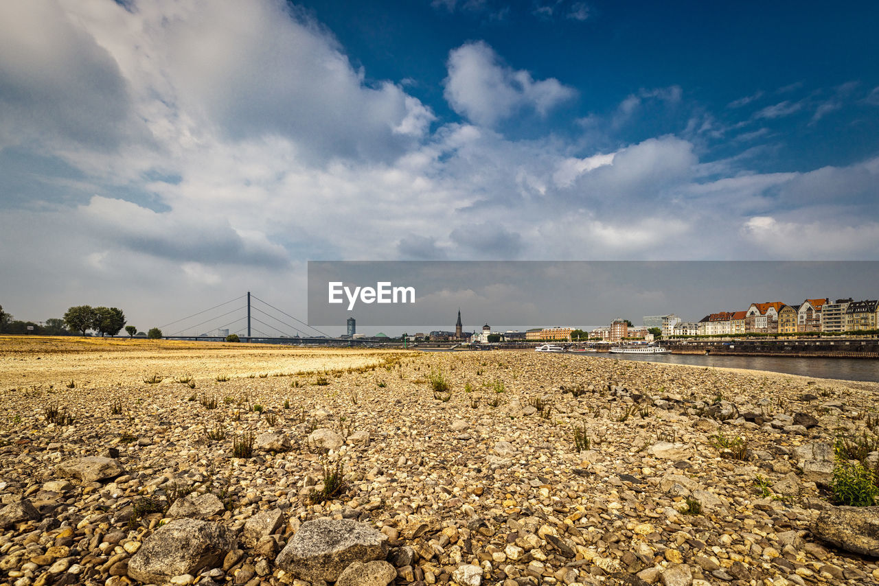 Series of low rhine level in düsseldorf 8.2022 with rhine tower and bridge