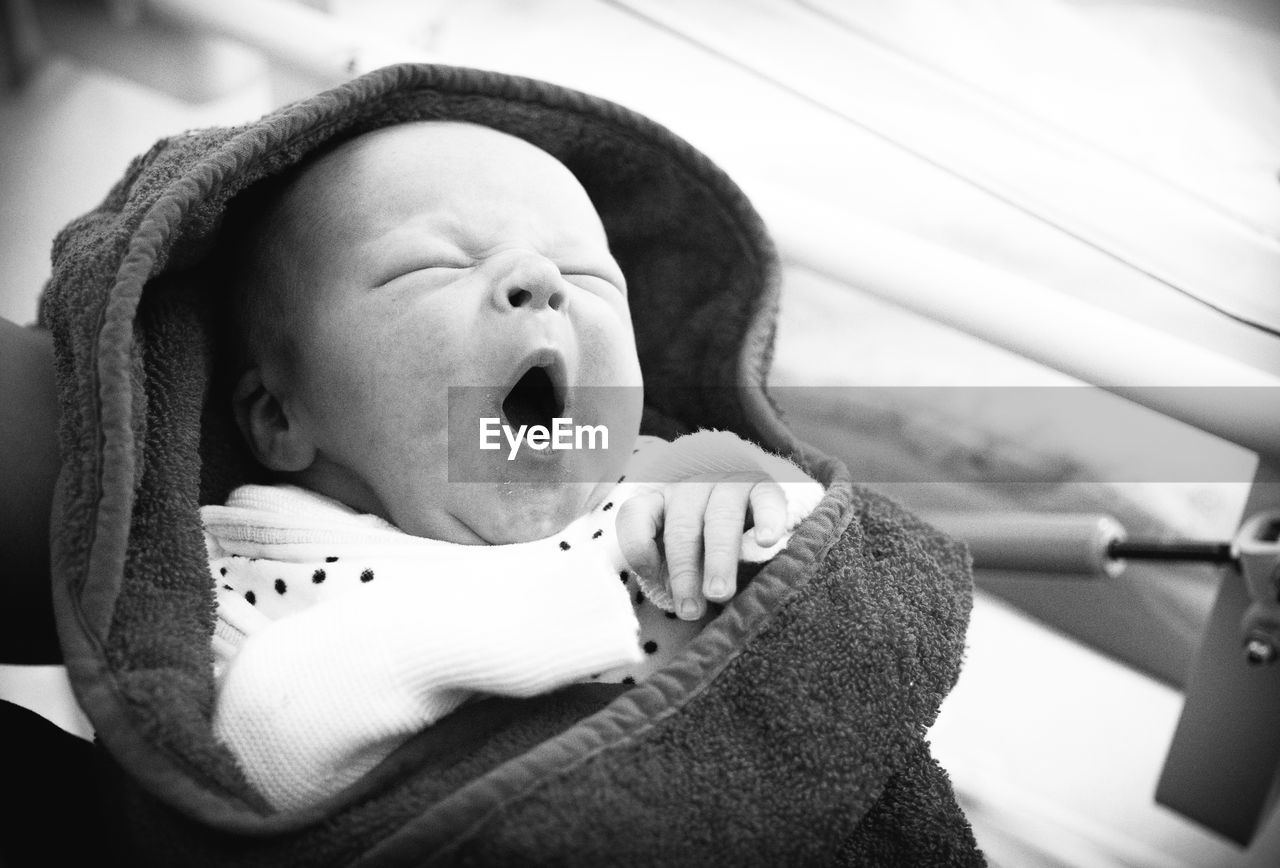 CLOSE-UP PORTRAIT OF CUTE BABY LYING ON BED