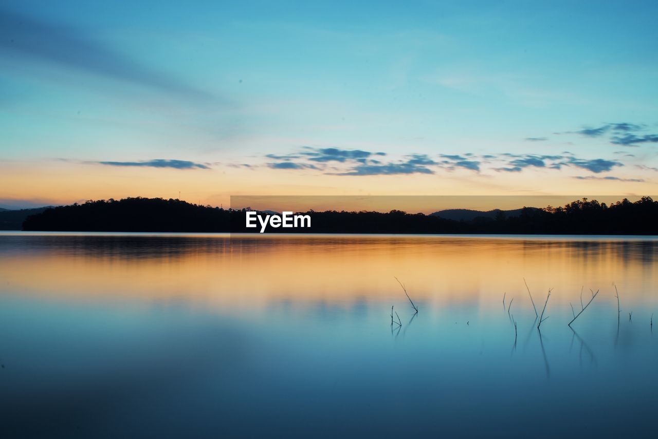 Scenic view of lake against sky during sunset